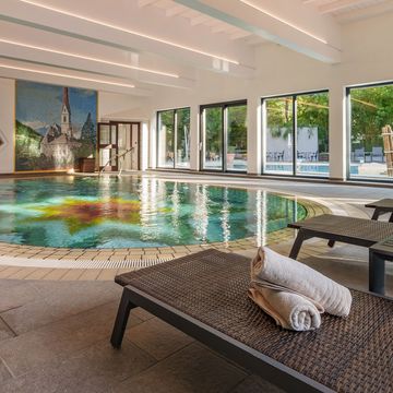 Außenpool des Hotel Vier Jahreszeiten in Schlanders im Vinschgau mit Liegewiese und Panorama